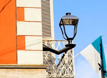 Low angle view of street light against building