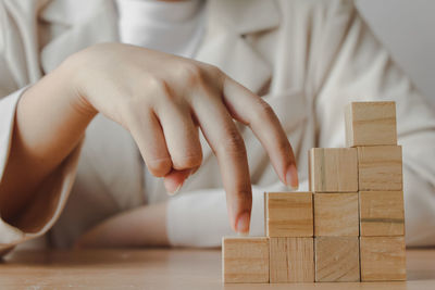 Midsection of woman with toy blocks