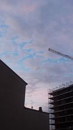 Low angle view of building against cloudy sky