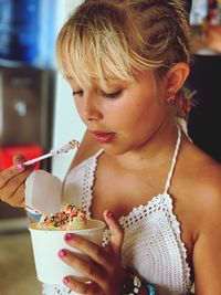 Close-up of girl eating ice cream at home