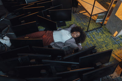 Businesswoman sleeping on floor in office