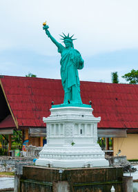 Low angle view of statue against cloudy sky