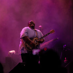 Man playing guitar at music concert