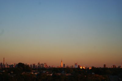 View of cityscape against clear sky during sunset