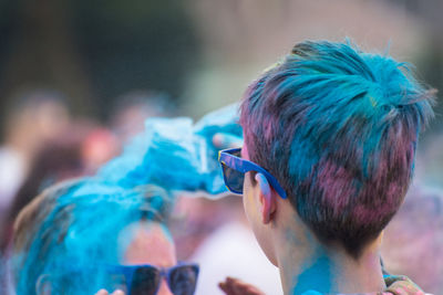 Rear view of boy covered with powder paint