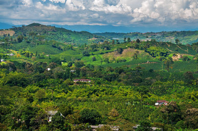 Scenic view of houses in the countryside against cloudy sky