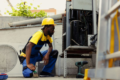 Rear view of man working at construction site