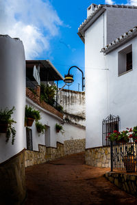 Houses and buildings in town against sky