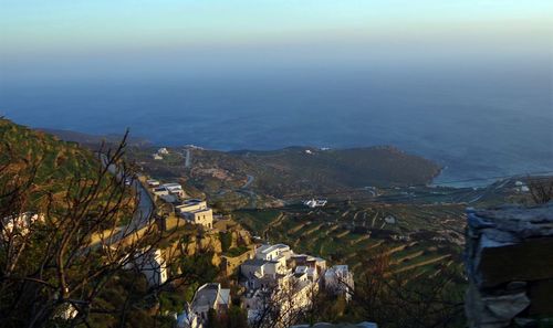 High angle view of buildings by sea against sky