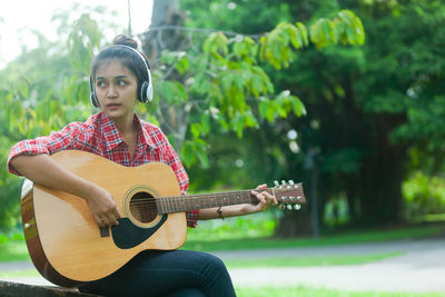 Young woman playing guitar