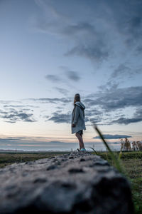 Full length of woman standing on land against sky