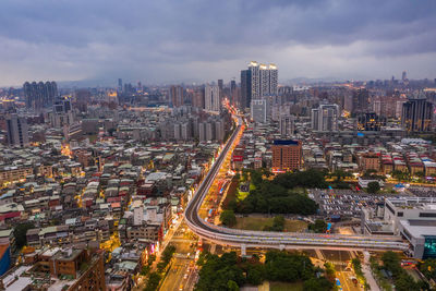 High angle view of city street and buildings against sky