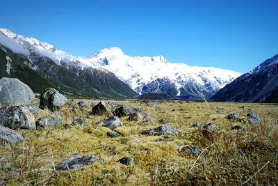 Scenic view of snowcapped mountains against blue sky