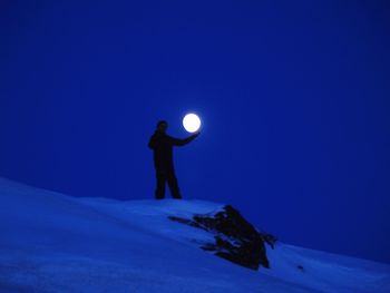 Woman standing on snow covered landscape