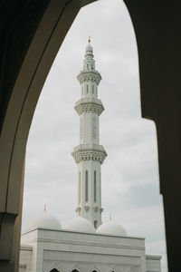 Mosque seen through arch against sky