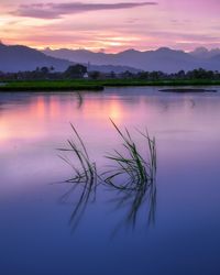 Scenic view of lake against sky during sunset