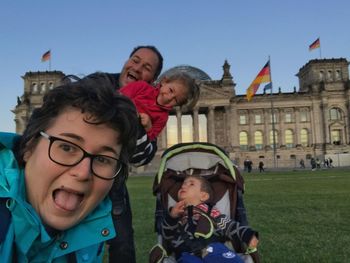 Portrait of happy family against sky