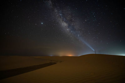 Scenic view of landscape against sky at night