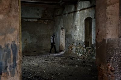 Woman walking in abandoned building