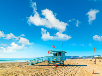 Lifeguard hut on beach against sky