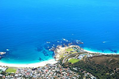 High angle view of sea shore against blue sky