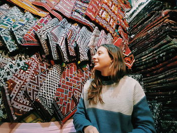 Smiling young woman standing in shop