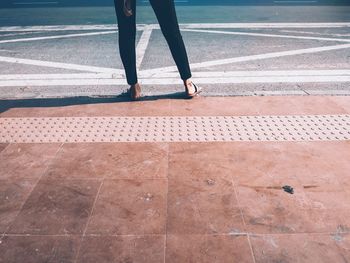 Low section of person walking on footpath