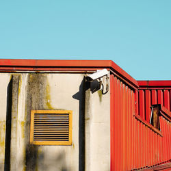 Low angle view of building against clear blue sky