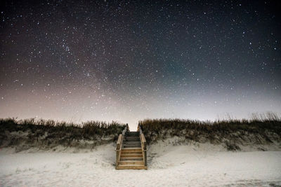 Scenic view of field against sky at night