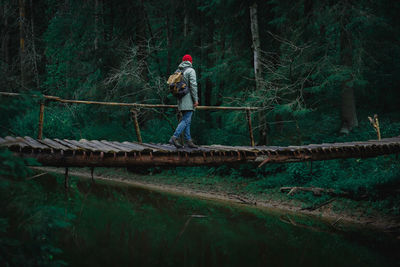 Full length of man walking in forest