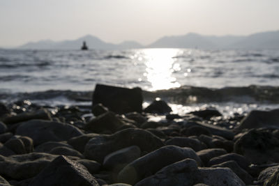 Rocks on beach against sky