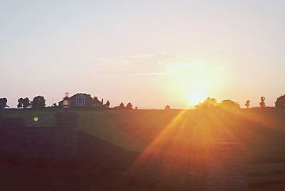 Silhouette people against clear sky during sunset