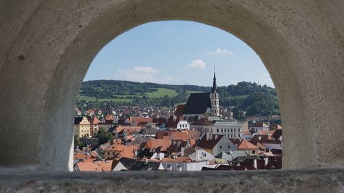 Buildings in town against cloudy sky