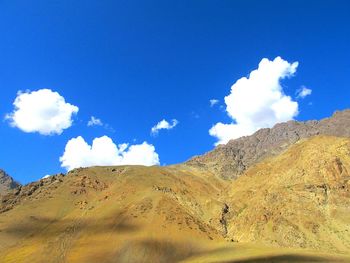 Scenic view of mountain against blue sky