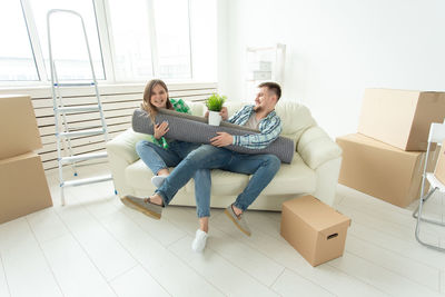 Young couple sitting on floor at home