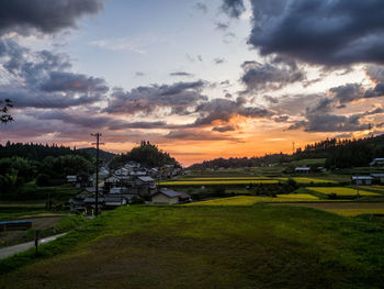 Scenic view of field against sky during sunset
