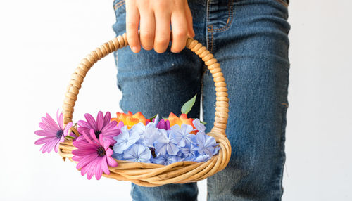 Low section of woman holding basket