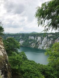 Scenic view of river amidst trees against sky