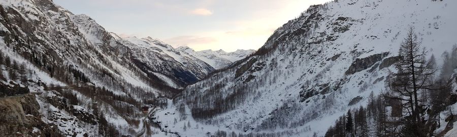 Scenic view of snow covered mountains against sky