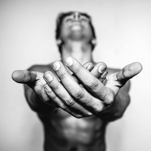 Portrait of man with hands against gray background