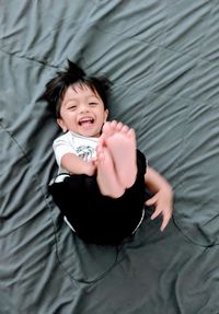 High angle view of baby girl lying on bed