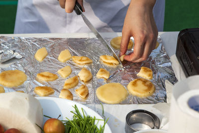 Midsection of chef slicing food