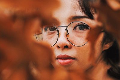 Close-up portrait of woman wearing eyeglasses during autumn