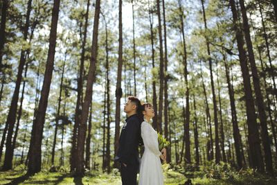 Portrait of woman standing in forest