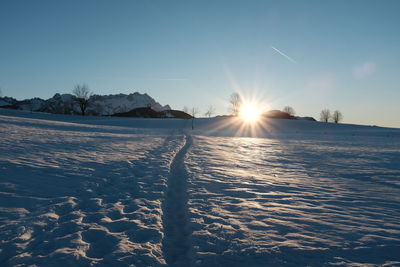 Scenic view of frozen lake against sky during sunset