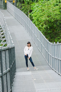 Full length of young woman standing on staircase