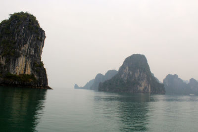 Rock formations on halong bay against clear sky