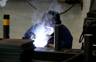 Man working on metal in kitchen