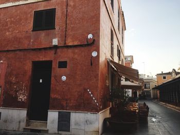 Street amidst buildings against sky