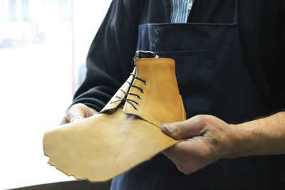 Close-up of man making shoe